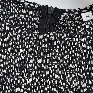 Black and white abstract polka dot dress with smocked elastic fabric and neck zipper