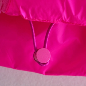 Detail of hot pink windproof vest showing adjustable elastic drawstring and round spring buckle