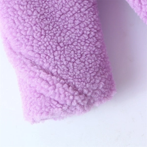Macro shot of lavender purple faux shearling fabric with soft curly grain texture