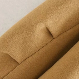 Front view of camel oversized fleece hoodie with pleated sleeve details for women
