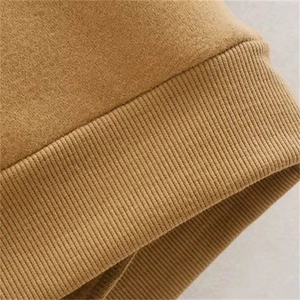 Macro shot of khaki hoodie sleeve with detailed ribbed cuff and premium knit texture