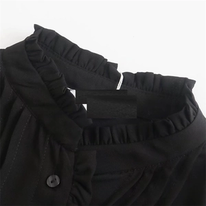 Camicia nera da donna con collo alto a volant e dettaglio chiusura con bottone