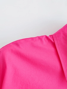 Close-up detail of high-quality stitching and poplin texture on a rose pink shirt