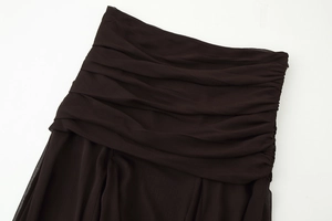 Detail of ruched dark brown semi-transparent chiffon skirt with elegant pleated texture