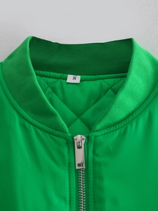 Close-up of bright green jacket collar with ribbed knit and diamond quilted lining