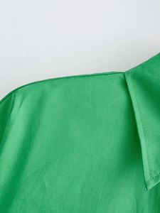 Detail shot of bright green poplin shirt collar and shoulder stitching texture