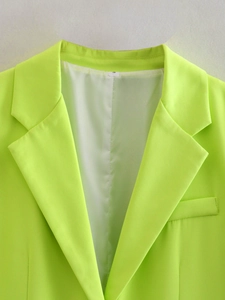 Detail view of neon green blazer showing size S label and smooth inner lining
