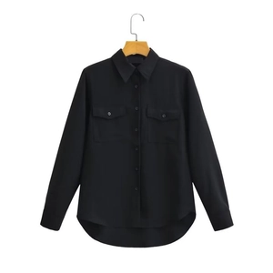 Women's black long-sleeve oversized blouse with front flap pockets and curved hemline