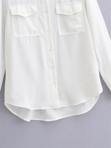 Women's white long sleeve button-up shirt with chest pockets and curved high-low hem