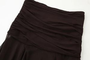 Detailed close-up of dark brown ruched chiffon fabric with delicate pleated texture