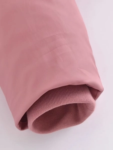 Close-up of pink puffer jacket cuffs with double-layer windproof knitted ribbed details
