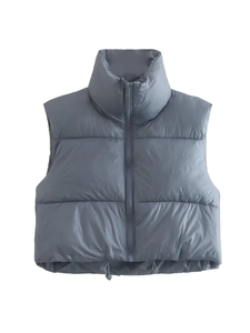 Detail view of puffer vest with stand collar, front zipper, and adjustable hem drawstring