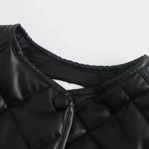 Detail of black quilted PU leather jacket collar with elastic ruching and button