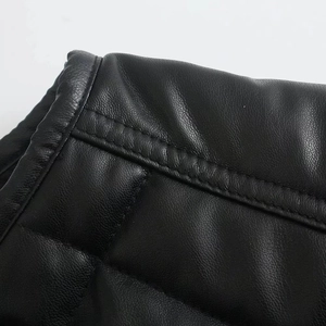 Macro detail of high-quality black PU leather with diamond quilting and stitching