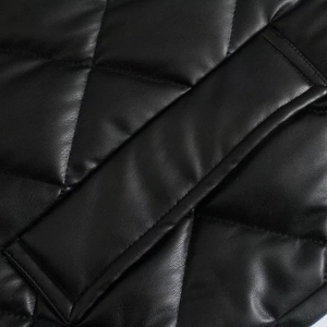 Detail of classic diamond quilted texture on black PU leather winter coat for women