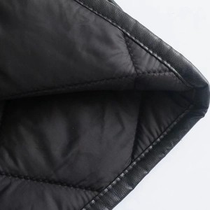 Detail view of black PU leather exterior and diamond quilted lining on winter jacket