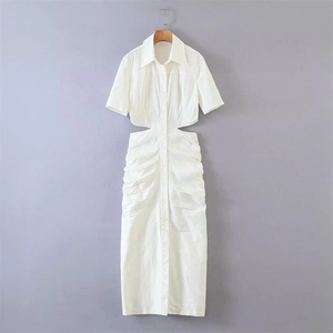 Detailed macro view of the white shirtdress showing cut-out waist and textured ruched fabric