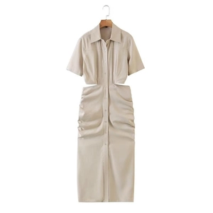 Detail view of beige shirt dress with side cut-outs and ruched skirt design