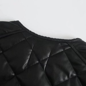 Detail of diamond quilted faux leather vest with round neck and premium stitching