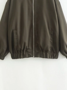 Détail du blouson aviateur vert olive avec fermeture éclair argentée et bord côtelé