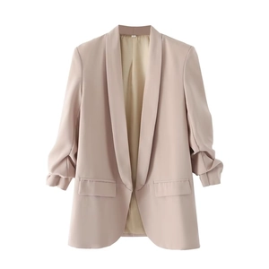 Detail view of pink shawl collar blazer with pleated sleeves and flat flap pockets