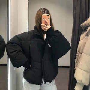 Oversized black winter puffer jacket with stand collar and loose silhouette for warmth