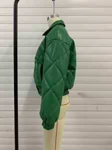 Detailed view of dark green quilted faux leather jacket with high stand-up collar design