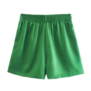 Bright green high-waisted satin shorts with elastic pleated waistband and silky finish