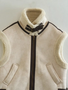 Detail view of winter suede vest with faux shearling lining and leather buckle collar