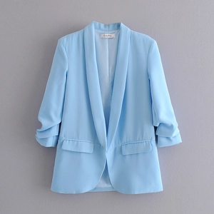 Detail of light blue blazer showing shawl collar design and ruched three-quarter sleeves