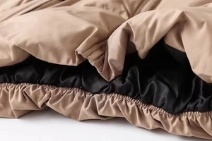 Detail of drawstring hem and premium lining on women's padded puffer jacket