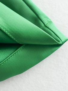 Close-up of green high-waisted shorts showing premium textile texture and double stitching