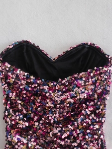 Detail of sweetheart neckline featuring colorful sequins and smooth black lining