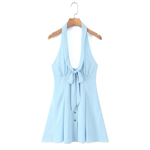 Close-up of light blue halter dress with V-neckline, bow tie and button detail
