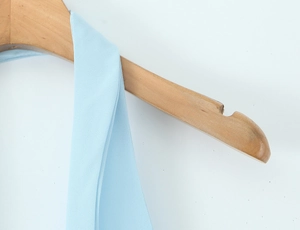 Detailed close-up of the V-neckline and stitching on the light blue halter dress