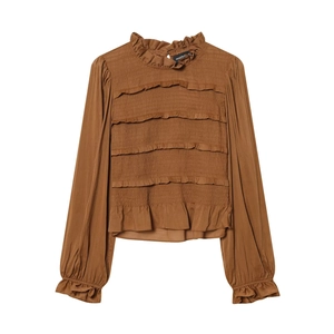 Detailed view of caramel long sleeve blouse with ruffled neckline and smocked chest texture