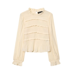 Detail of tiered ruffles and elastic smocking on a beige long sleeve chiffon top
