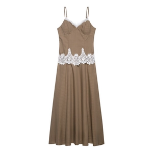 Close-up of brown striped maxi dress featuring white lace trim and intricate waist embroidery