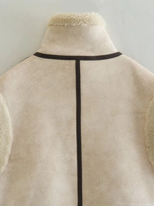 Detail of faux suede vest with faux fur lining and contrast leather trim on back