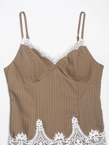 Detail of brown striped camisole top with intricate white lace trim and slim straps