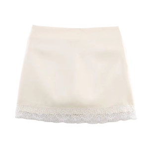 Close-up of cream satin mini skirt featuring delicate white floral lace hem stitching