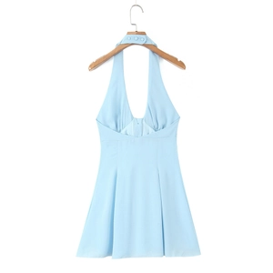 Detail of light blue halter dress featuring a deep V-neck and three decorative buttons