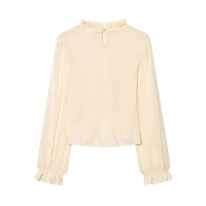 Detail of smocked texture and ruffle high neck on pale yellow long sleeve top