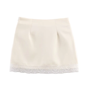 Macro detail of high-waist mini skirt featuring delicate lace hem and invisible side zipper