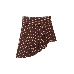 Detailed view of dark brown polka dot mini skirt with asymmetric ruffled hemline