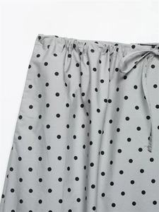 Detail of grey polka dot skirt showing elastic waist with adjustable drawstring cord