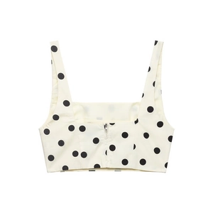 Close-up of white cropped tank top with black polka dots and back zipper detail