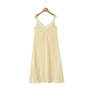 Close-up of V-neckline with delicate white lace trim and bow shoulder straps on dress