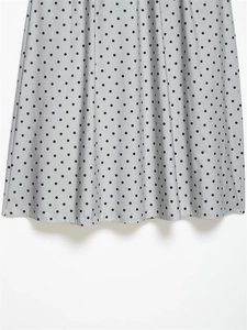 Detailed view of the light grey polka dot hemline fabric with soft pleats and texture