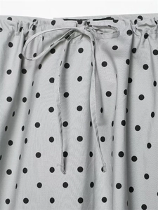 Detail of grey polka dot skirt showing elastic waist and adjustable drawstring cord
